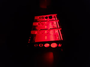 Side view of Bratco Innovations red lighted pedalboard in the dark